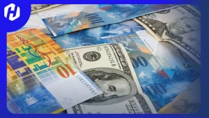 Kemunculan pasangan mata uang USD/CHF menggambarkan hubungan antara Dolar Amerika Serikat dan Franc Swiss.